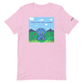 Pink t-shirt with a cartoon dinosaur graphic and text on scenic background
