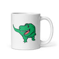 White mug with a green dinosaur design on a white background